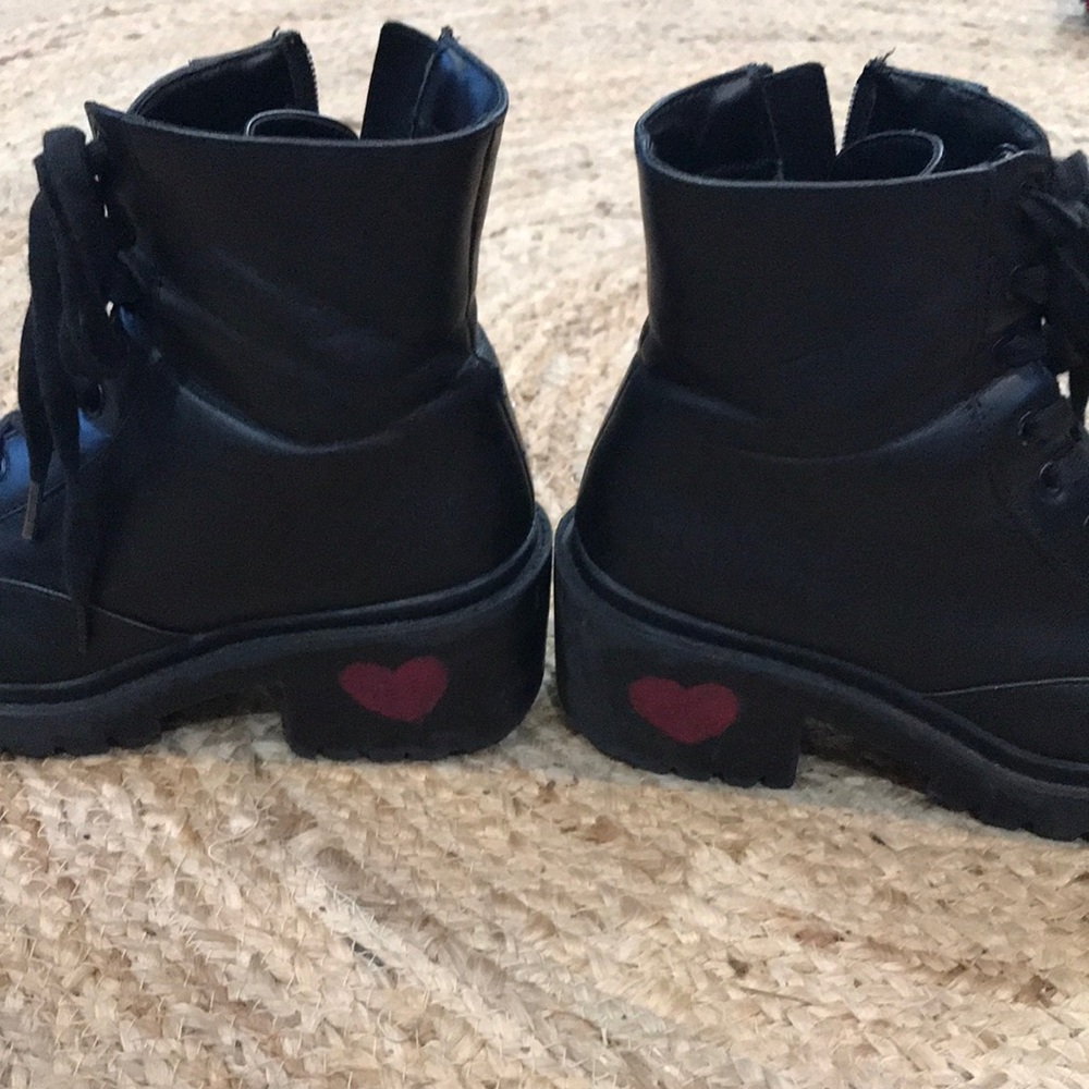 Black heeled combat boots with hand painted hearts on the heels